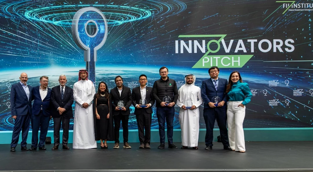 FII Innovators Pitch winners hold their awards on stage with FII Institute leadership.