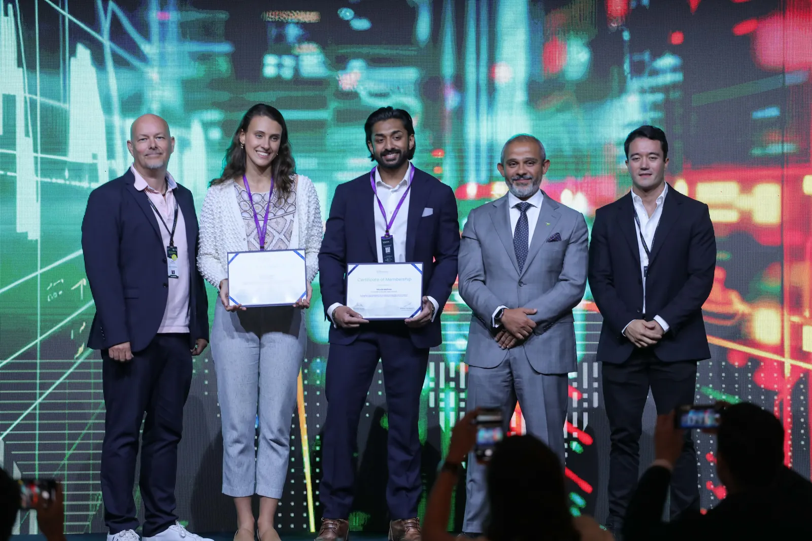 Winners receive their certificates on stage at FII Innovators Pitch.